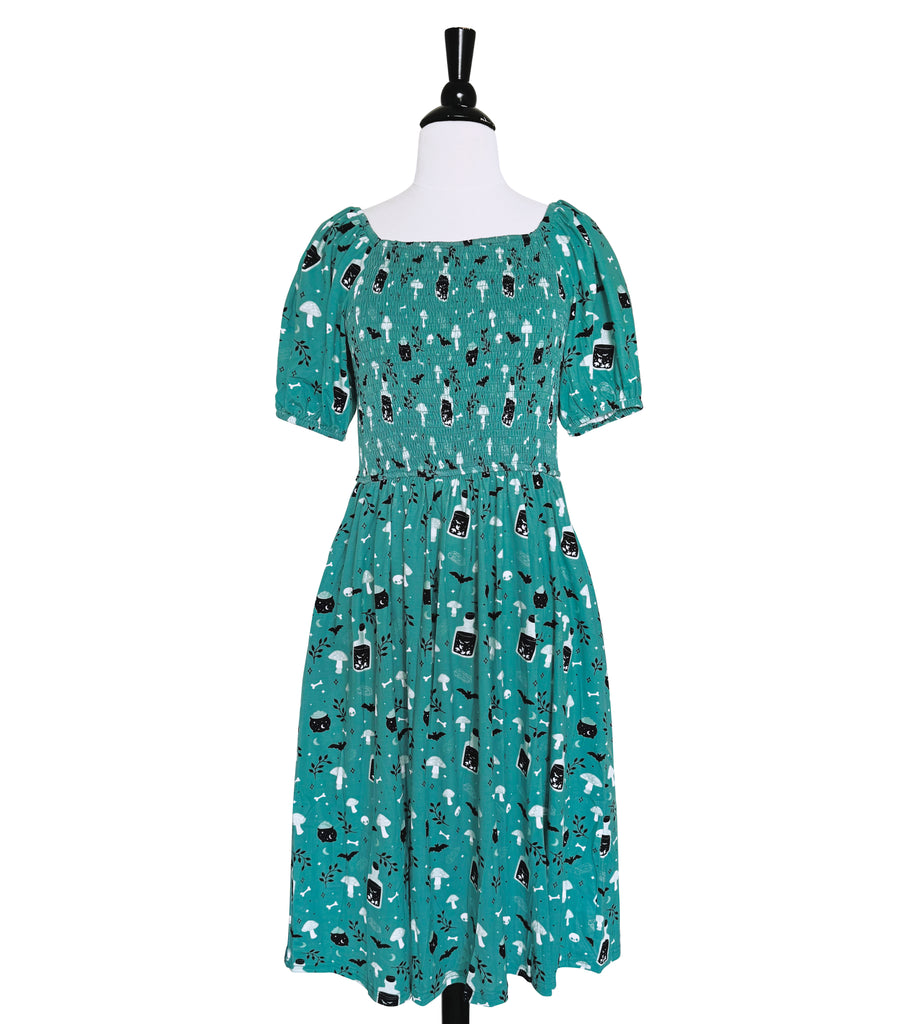 Witchy Potions Smocked Midi Dress - Available in sizes S to 4X Em & Sprout Witchy Potions Smocked Midi Dress - Available in sizes S to 4X Em & Sprout
